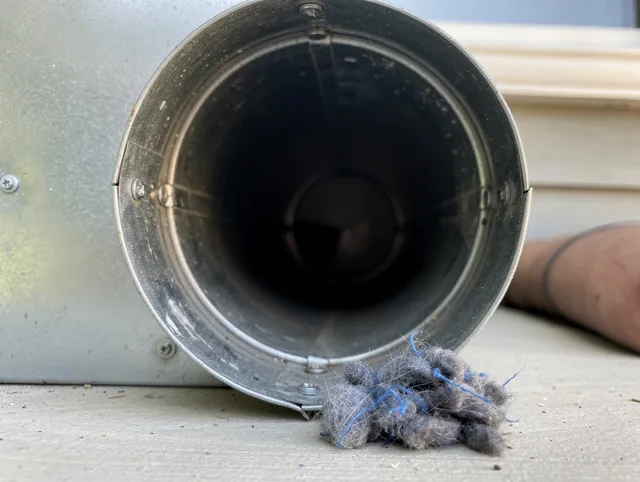 Brooklyn Dryer Vent Cleaning technician using specialized equipment to clear severe dryer vent blockage in Brooklyn